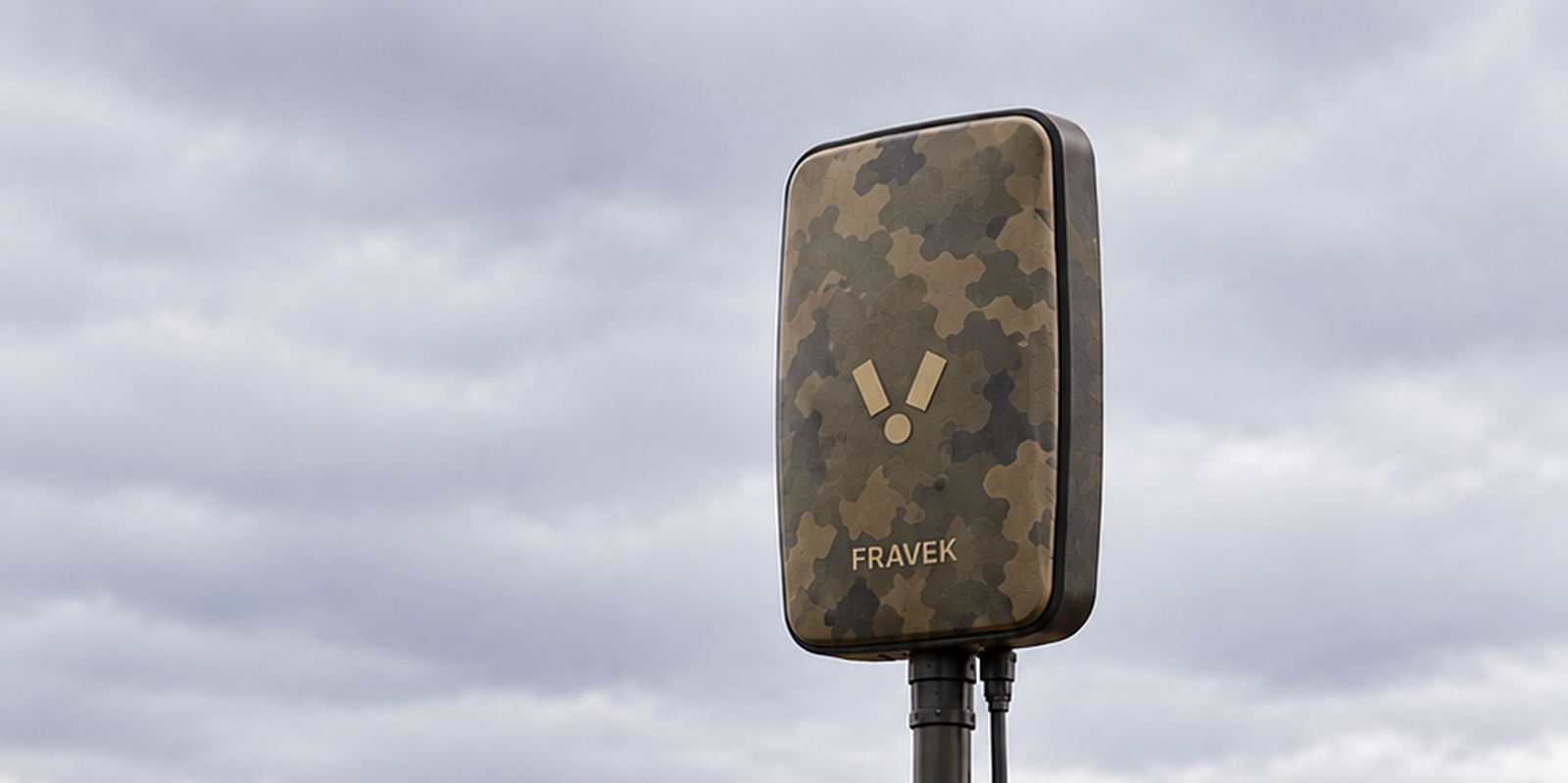 Camouflaged passive sensing node on a tripod in a harvested field